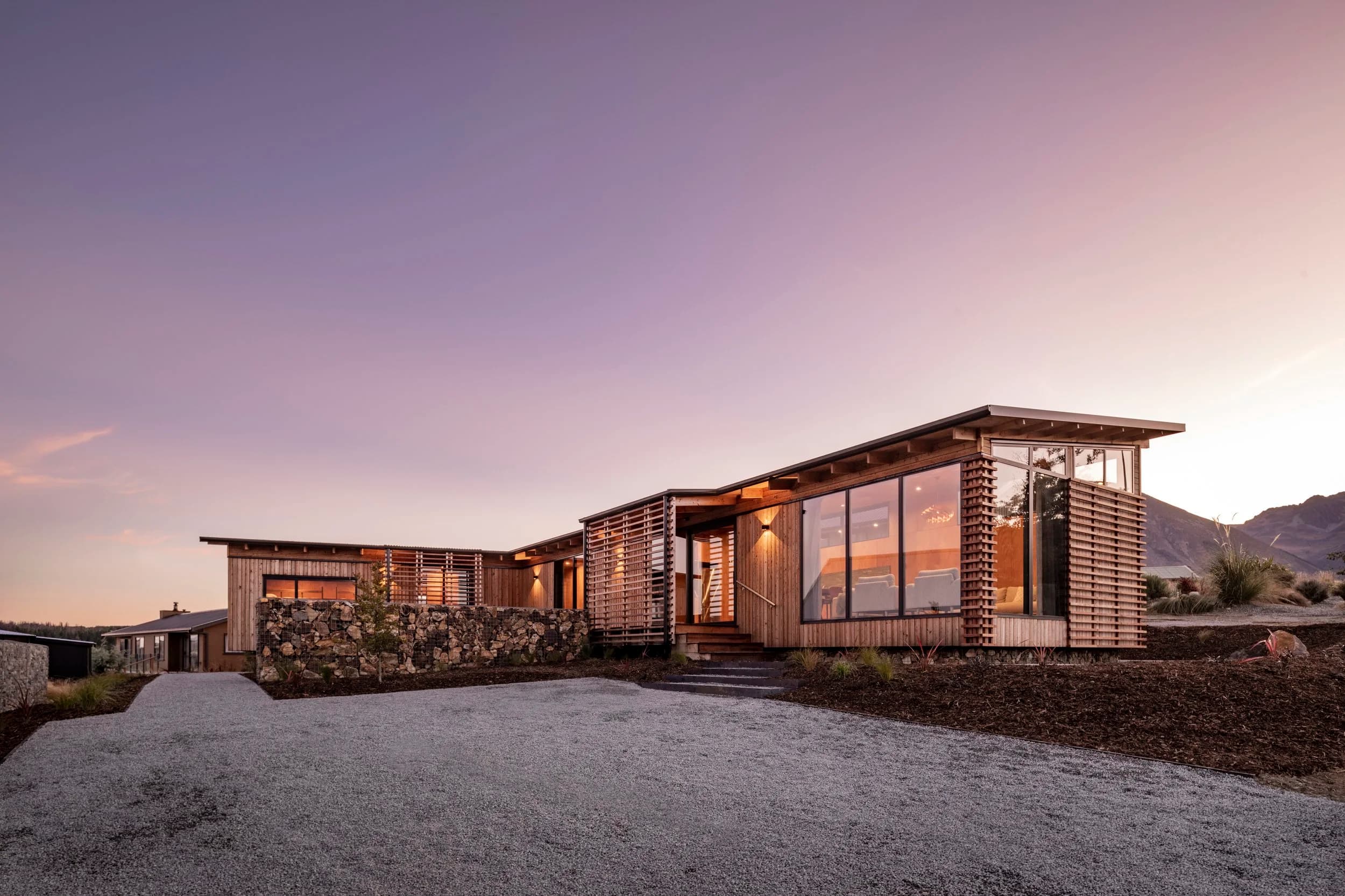 Lake Ōhau retreat, a larch and volcanic rock bach designed by Archco